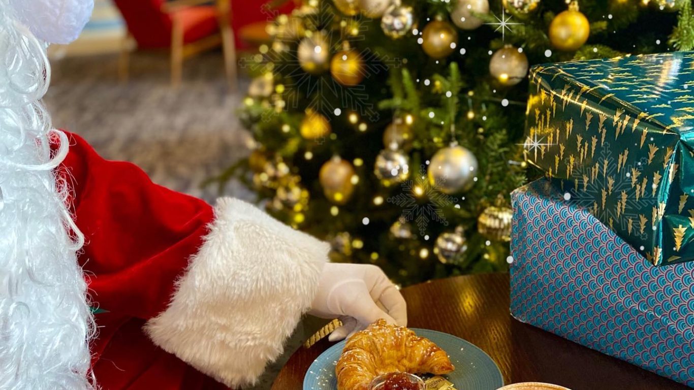 Santa in the lobby with coffee