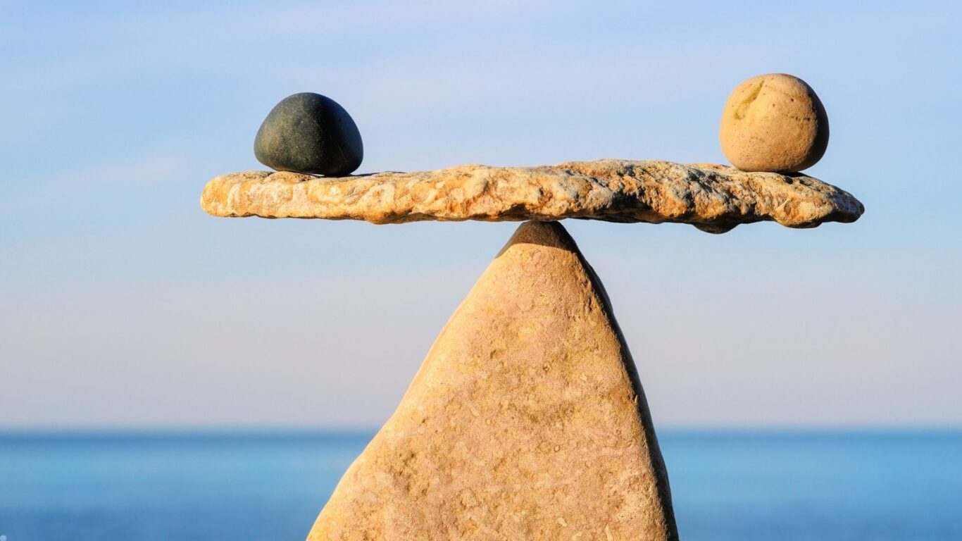 Experience tranquillity with a balanced rock sculpture against a serene ocean backdrop, embodying our peaceful beachfront retreat.